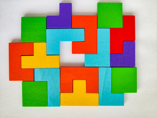 Details of a wooden multi-colored puzzle. Pieces of a color puzzle puzzle on an isolated background.