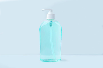 A big bottle with antiseptic sanitizer gel for washing hands on blue background. Alcohol gel as coronavirus prevention. Viral disease prevention concept. Copy space for text