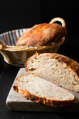 Home Cooking Homemade Organic Sourdough bread on black background with copy space