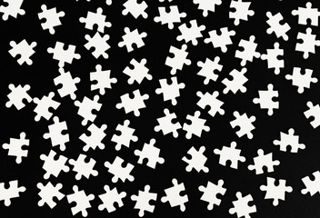 Elements of a white puzzle on a black background