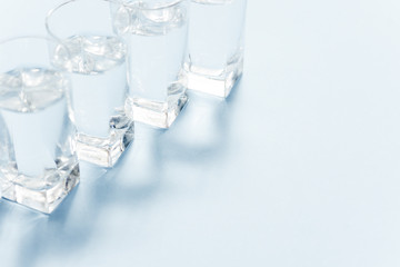 Water filters. Carbon cartridges and glasses on a blue background. Household filtration system.