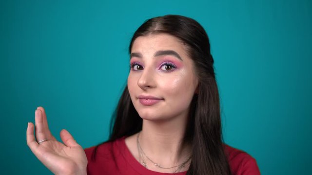 annoyed woman in perplexity looking at camera, waving hand, negative emotions