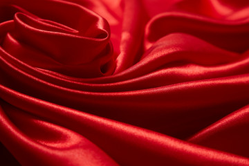 Obraz premium Luxury red satin smooth fabric background for celebration, ceremony, event invitation card or advertising poster