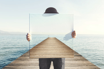 Man holding surreal painting of a boardwalk - obrazy, fototapety, plakaty