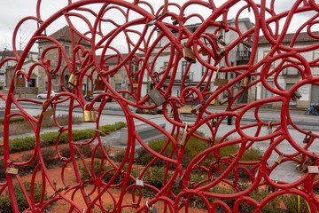 Big red heart shaped lock with love padlocks at Praca do Municipio in Vila Verde, district of Braga...