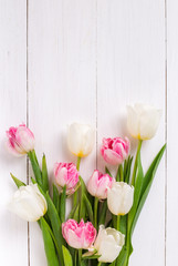 Obraz na płótnie Canvas Beautiful tulips on white wooden background