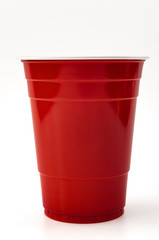 Partying, american drinking games and party supplies concept with red plastic cup isolated on white background with clipping path cutout