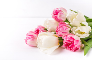 Beautiful tulips on white wooden background