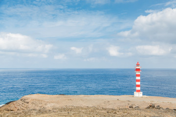 Lighthouse on Gran Canaria in daylight - Faro de Punta Sardina on cliffs