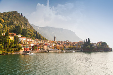 Fototapeta na wymiar Colorful town Varenna seen from Lake Como on a sunny day