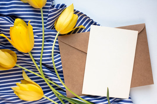 card mockup, tulips and lilies of the valley on white table