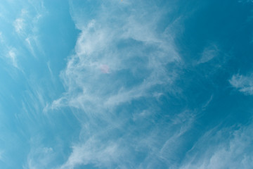 Soft white clouds against blue sky background.