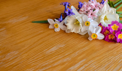Spring bouquet of fresh white narcissus on wooden table. Bouquet of daffodil flowers on brown background. Copy space. Top view