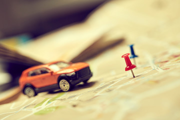 travel concept - small toy car on the map