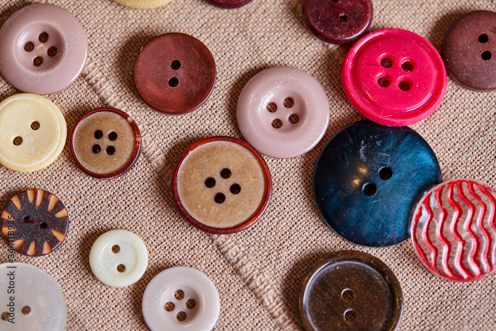 Poster background and texture of multicolored antique buttons and sewing tools