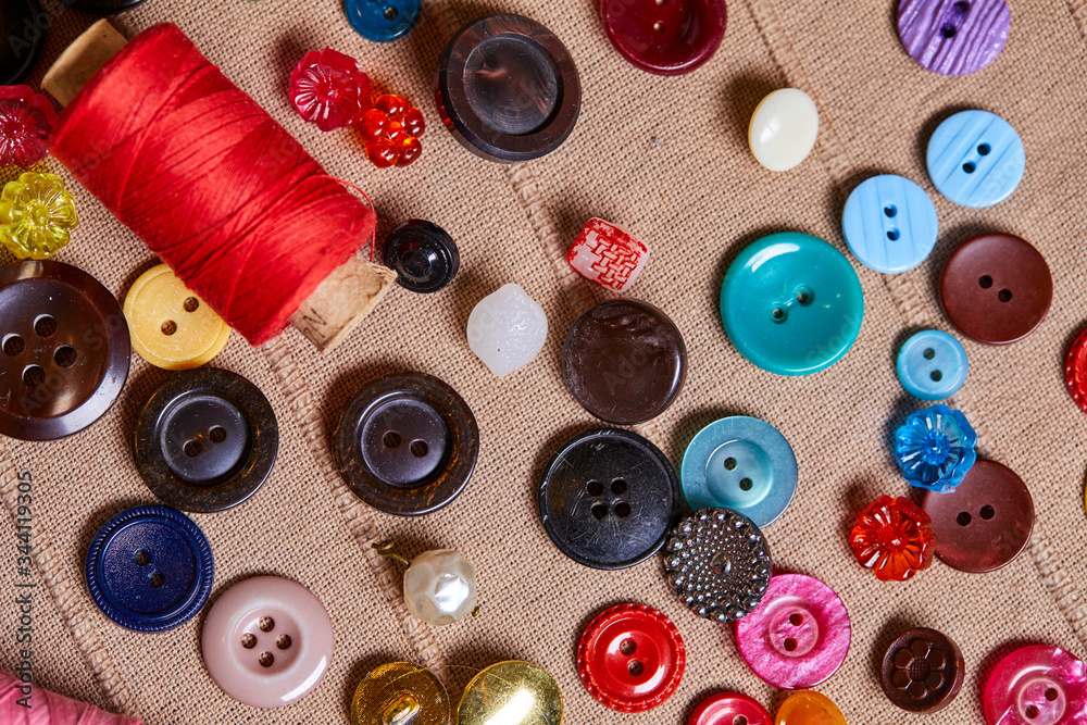 Poster background and texture of multicolored antique buttons and sewing tools