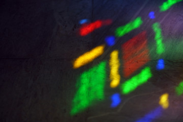 colors of a stained glass window reflected on the floor