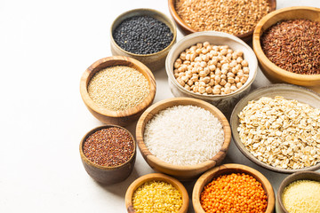 Organic products. Bowls with different gluten free grains on white background