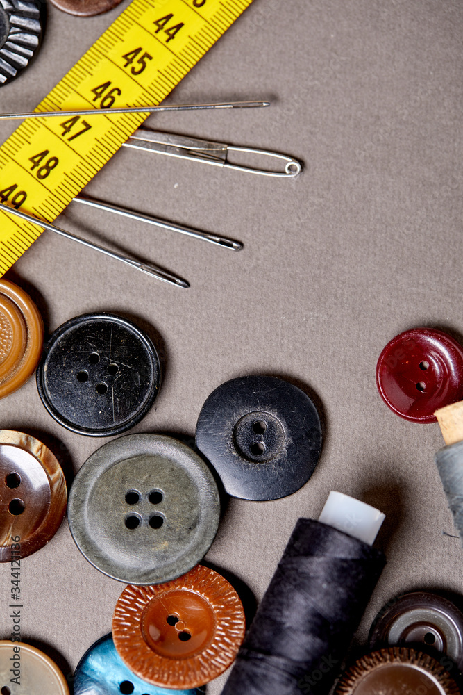Poster background and texture of multicolored antique buttons and sewing tools