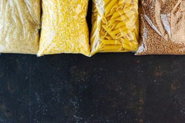Food supply quarantine food crisis isolated on black concrete background. Rice, pasta, corn flakes,...