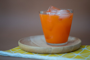 Glass of fresh carrot with ice.