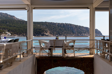 beautiful laid table in a restaurant overlooking the mediterranean sea in sant elm, mallorca, spain