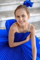 Ballerina dancer girl in a trendy colored classic blue paper dress with handmade white swan. Girl dreaming to become professional ballet dancer, classical dance school.  Young sweet fairy ballerina 