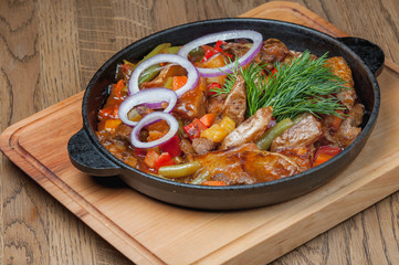 baked meat stew with vegetables in a pan