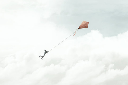 man flying with his red kite in the sky, surreal