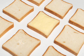 slices of wheaten bread spreaded with butter. pattern