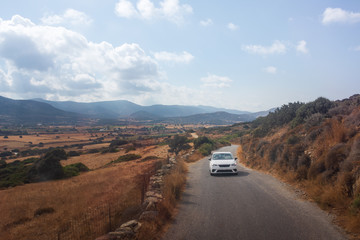 Car driving along rural road on Greek island of Naxos