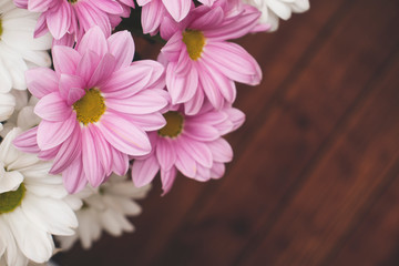 Background with an inscription field and a bright bouquet of gerberas in the corner. A bouquet of gerberas, creating an upbeat spring mood.