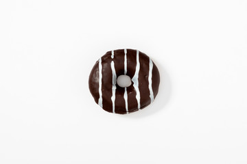 Tasty chocolate donut on white background. Flat lay, top view, copy space