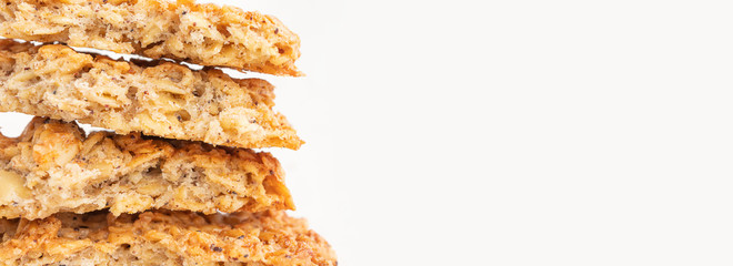 Homemade fresh appetizing oatmeal cookies close-up. The concept of healthy breakfast, homemade food. Light background. Banner 16:9. On the right there is a place for text.