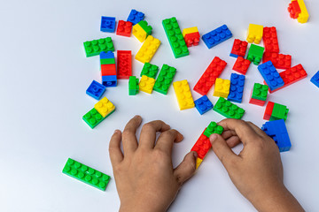 Thailand, bangkok. April 29, 2020. Children hands play with colorful blocks on white background.