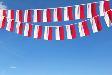 Indonesia flag festive bunting hanging against a blue sky. 3D Render