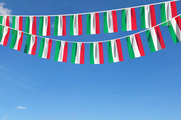 Hungary flag festive bunting hanging against a blue sky. 3D Render