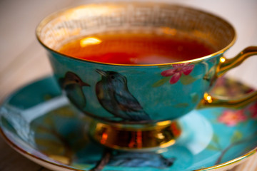 Blue porcelain teacup with black tea
