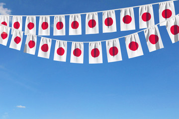 Japan flag festive bunting hanging against a blue sky. 3D Render