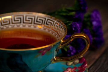 Blue porcelain teacup with black tea