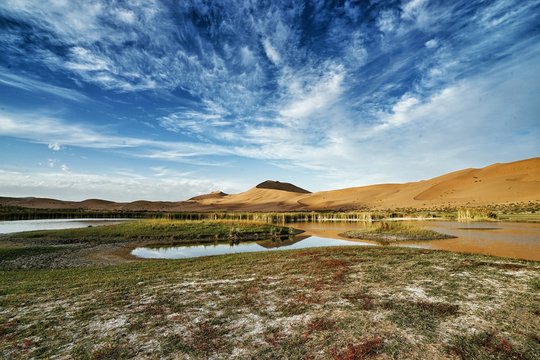 Scenic View Of Lake By Mountains At Badain Jaran Desert
