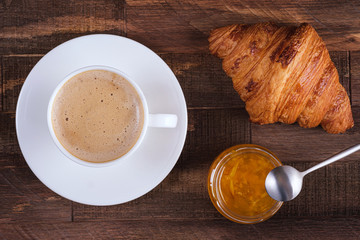 Directly above cap coffee cappuccino and croissant with jam