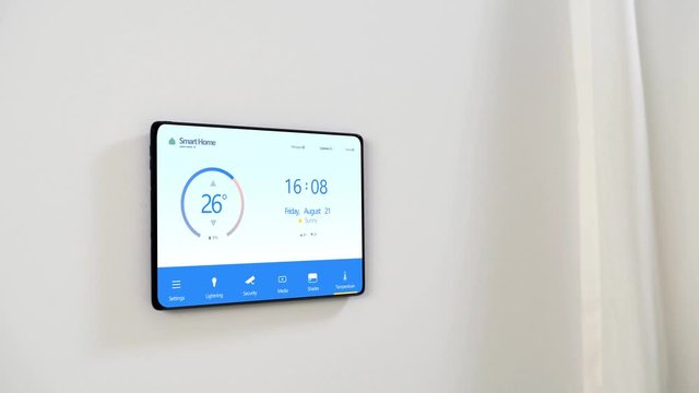 automation, internet of things and technology concept - tablet pc computer with smart home settings on screen on wall