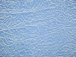 Crumpled blue brocade fabric texture background