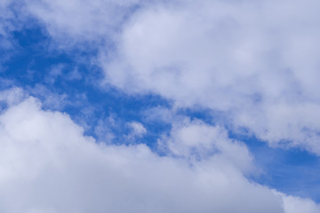 Aerial view of white clouds against blue sky background texture. Space for text.