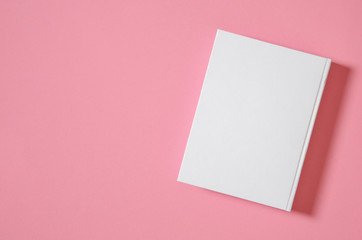Fototapeta na wymiar Mockup of closed blank square book at white textured paper