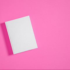 Fototapeta na wymiar Mockup of closed blank square book at white textured paper