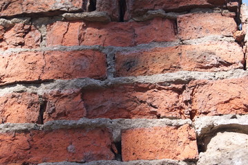 A fragment of an old red brick wall.