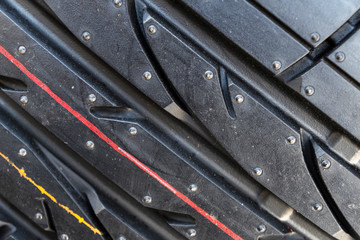 Summer car tire. Tire stack background. Car tyre protector close up view. Black rubber tire background. New car tires. Close up black tyre profile texture