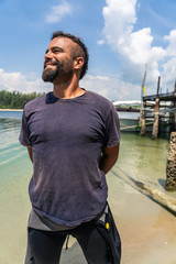 Smiling young man in a wetsuit.